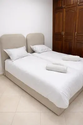 a large white bed with two pillows on it at Appartement 2 Chambres 2 Balcons Gueliz in Marrakech