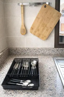 a tray of utensils on a kitchen counter with a cutting board at Appartement 2 Chambres 2 Balcons Gueliz in Marrakech