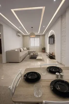 a living room with a table with plates on it at Appartement 2 Chambres 2 Balcons Gueliz in Marrakech