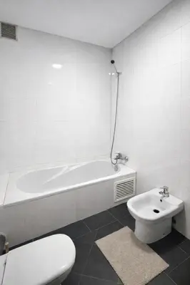 a bathroom with a tub and a toilet and a sink at Appartement 2 Chambres 2 Balcons Gueliz in Marrakech