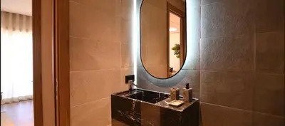 a bathroom with a sink and a mirror at Luxury Apartment in Marrakech