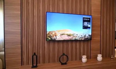 a flat screen tv hanging on a wooden wall at Luxury Apartment in Marrakech