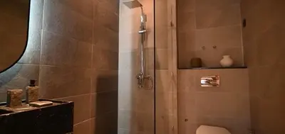 a shower with a glass door in a bathroom at Luxury Apartment in Marrakech