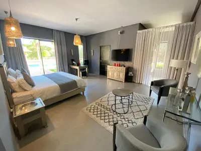a bedroom with a bed and a living room at Villa Ines Piscine chauffée & Jacuzzi & Hammam in Marrakech