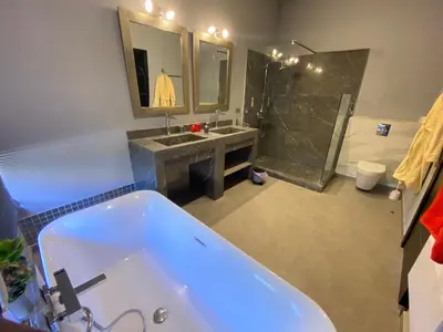 a bathroom with a tub and a sink and a shower at Villa Ines Piscine chauffée & Jacuzzi & Hammam in Marrakech