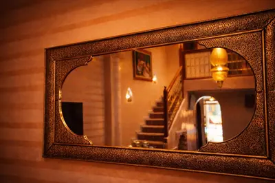 a mirror on a wall with a staircase in a room at Riad 16 Dar and Pool in Marrakech