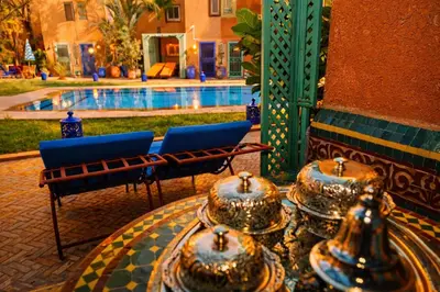 a patio with two chairs and a swimming pool at Riad 16 Dar and Pool in Marrakech
