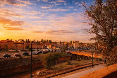 a city street with cars parked in a parking lot at Riad 16 Dar and Pool in Marrakech