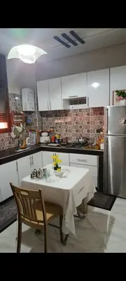 a kitchen with a table and chairs and a refrigerator at Afaq1,saada in Marrakech