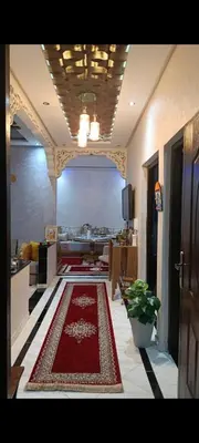 a living room with a red rug on the floor at Afaq1,saada in Marrakech