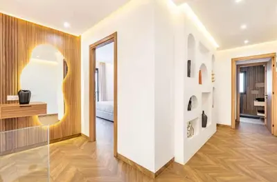 a room with a white wall and a mirror at Kais in El Rhechat