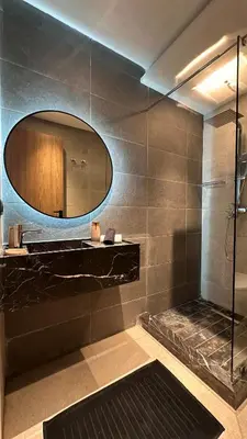 a bathroom with a large mirror and a shower at Marrakesh Heated Pool Sport and Jacuzzi in Marrakech