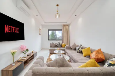 a living room with two couches and a tv at The best JINANE in Marrakech