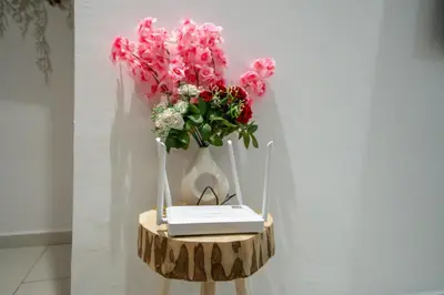a table with a vase of flowers and a book at The best JINANE in Marrakech