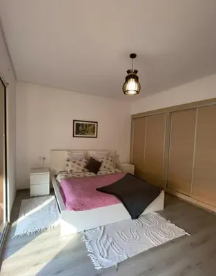 a bedroom with a large bed with a pink blanket at Studio Premium au Cœur de Guéliz in Marrakech