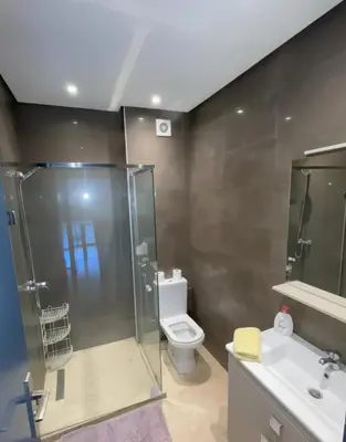 a bathroom with a shower and a toilet and a sink at Studio Premium au Cœur de Guéliz in Marrakech