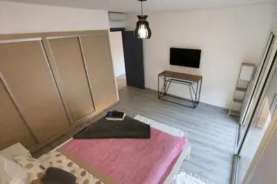 a room with a bed and a television in it at Studio Premium au Cœur de Guéliz in Marrakech