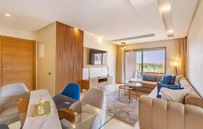 a living room with a couch and a table at Prestigia Golf Resort Luxury in Marrakech