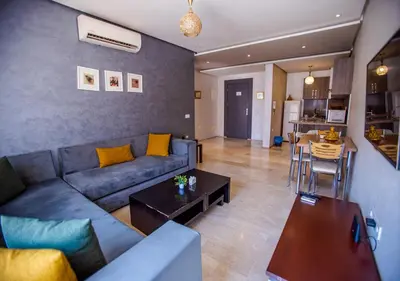 a living room with a couch and a table at Le Chic Urbain Tout à Pied Clim Design Chic in Marrakech