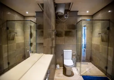 a bathroom with a toilet and a shower at Le Chic Urbain Tout à Pied Clim Design Chic in Marrakech