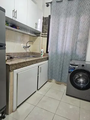 a kitchen with a sink and a washing machine at Chya home in Marrakech