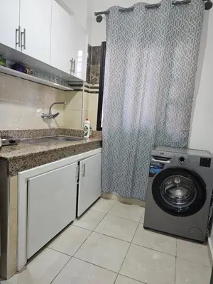 a kitchen with a washing machine in a kitchen at Chya home in Marrakech