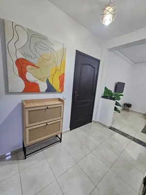 a room with a dresser and a painting on the wall at Chya home in Marrakech