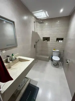a white bathroom with a toilet and a sink at Appartement familial Marrakech in Marrakech