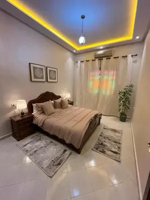 a bedroom with a bed and a window with rugs at Appartement familial Marrakech in Marrakech