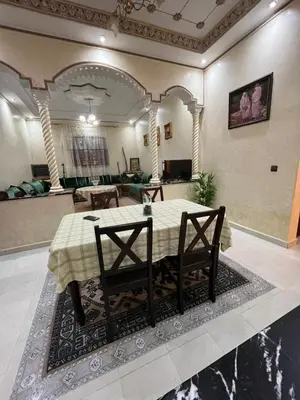 a dining room with a table and two chairs at Appartement familial Marrakech in Marrakech
