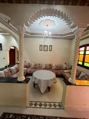 a living room with a couch and a table at Appartement familial Marrakech in Marrakech
