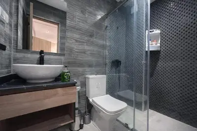 a bathroom with a toilet and a sink and a shower at cosy proche Jardin Majorelle in Marrakech