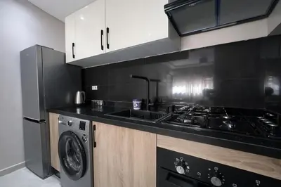 a kitchen with a stove and a sink and a dishwasher at cosy proche Jardin Majorelle in Marrakech
