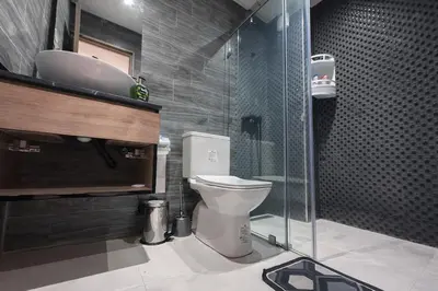 a bathroom with a toilet and a glass shower at cosy proche Jardin Majorelle in Marrakech