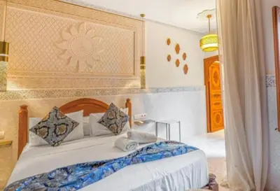 a bedroom with a large bed with aokedokedokedoked at Riad dar salima in Marrakech