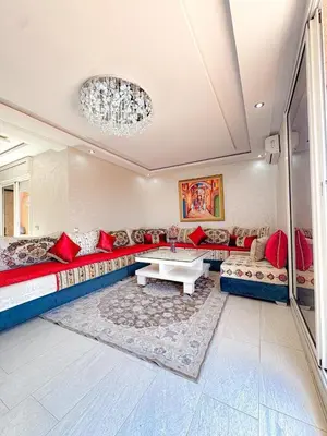 a living room with a couch and a table at Appartement de luxe Marrakech - Targa in Marrakech