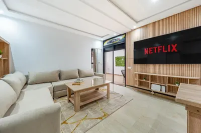 a living room with a couch and a tv at Horizon Cozy terrace and serenity in Marrakech