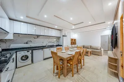 a kitchen with a table and chairs in a room at Horizon Cozy terrace and serenity in Marrakech