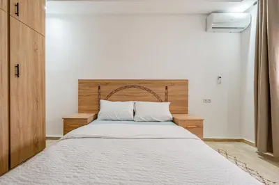 a bedroom with a large bed with a wooden headboard at Horizon Cozy terrace and serenity in Marrakech