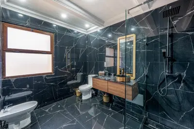 a bathroom with a sink and a toilet and a mirror at Andalusian Dream Villa pool and balcony in Marrakech