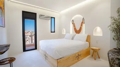 a white bedroom with a bed and a window at Majorelle Garden - Design apartment in Marrakech