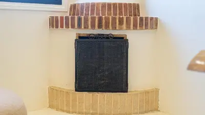 a fireplace in the corner of a room at Majorelle Garden - Design apartment in Marrakech