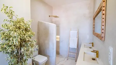 a bathroom with a sink and a toilet and a mirror at Majorelle Garden - Design apartment in Marrakech