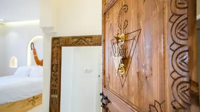 a room with a wooden door with a mirror at Majorelle Garden - Design apartment in Marrakech