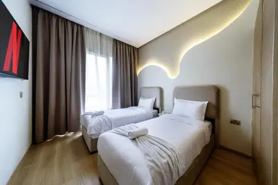 a hotel room with two beds and a window at Prestigia Exceptional apartment with pool view in Marrakech