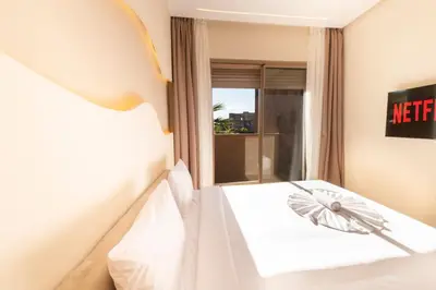 a hotel room with a bed and a window at Prestigia Exceptional apartment with pool view in Marrakech