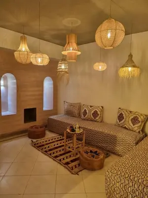 a living room with a couch and a table at Palais Majorelle - Entire Chic 3Bedrms 3Bathrms Duplex in Marrakech with Majorelle View, 2 Lounges, Prime Central Location in Marrakech