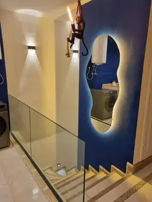 a woman is jumping off a wall in a bathroom at Palais Majorelle - Entire Chic 3Bedrms 3Bathrms Duplex in Marrakech with Majorelle View, 2 Lounges, Prime Central Location in Marrakech