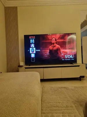a flat screen tv sitting in a living room at Palais Majorelle - Entire Chic 3Bedrms 3Bathrms Duplex in Marrakech with Majorelle View, 2 Lounges, Prime Central Location in Marrakech