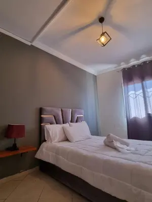 a bedroom with a bed with white sheets and a window at Palais Majorelle - Entire Chic 3Bedrms 3Bathrms Duplex in Marrakech with Majorelle View, 2 Lounges, Prime Central Location in Marrakech